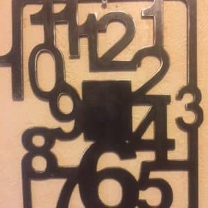Horloge chiffres mêlés en métal découpé